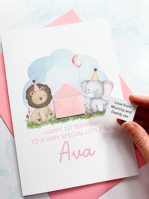 A Personalised Greeting Card for a little girl, featuring a secret keepsake message inside a handcrafted 3d mini envelope. The front features cute watercolour safari animals including a lion and elephant, along with a birthday balloon. The text reads Happy 1st Birthday to a very special little girl and the recipient's name