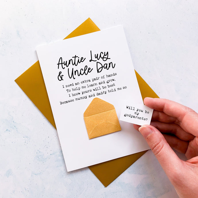 A personalised handmade greeting card featuring a godparents proposal message hidden inside a mini 3d envelope on the front. The front of the card reads 'I need an extra pair of hands To help me learn and grow, I know yours will be Best Because mummy and daddy told me so