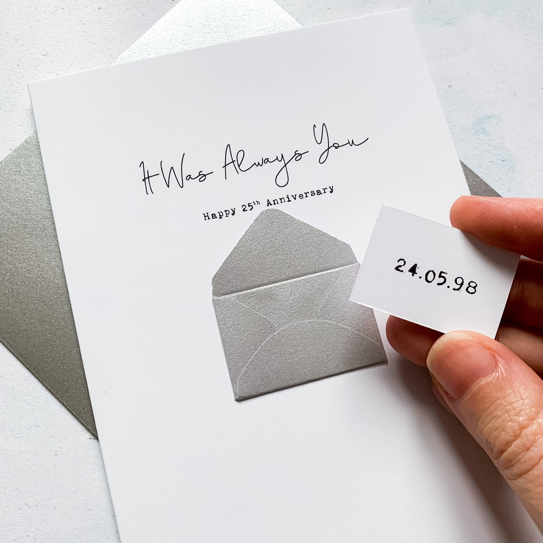 A personalised 25th anniversary greeting card featuring a secret message hidden inside a silver mini 3d envelope on the front of the card. Text on the front reads It Was Always You, with the wedding date on the mini token inside the tiny envelope