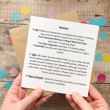 Load image into Gallery viewer, A person's hands holding a paper with text and a list of UK orders, including details about shipping and international orders.