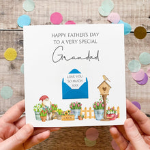 Load image into Gallery viewer, A handmade Father's Day card with illustrations of a garden, a gnome, and a birdhouse. The card has a message that reads "Happy Father's day to a very special Grandad" and includes a blue envelope with a heart and the text "LOVE YOU SO MUCH XXX".