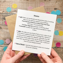 Load image into Gallery viewer, A person's hands holding a paper with text and a list of UK orders, including details about shipping and international orders.